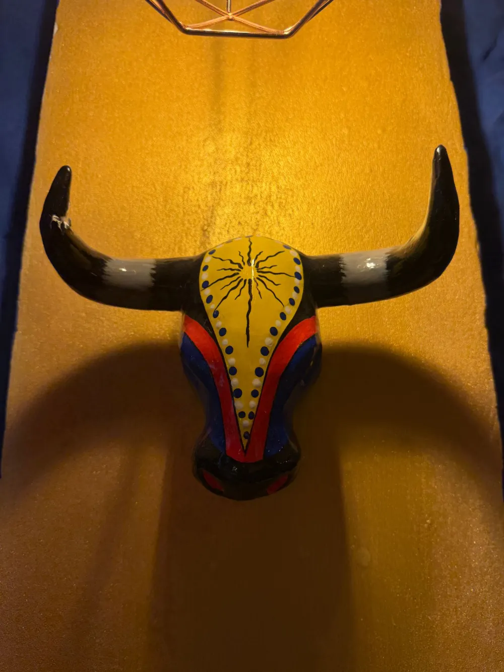 Bull's head painted in Colombian colors in the dining room